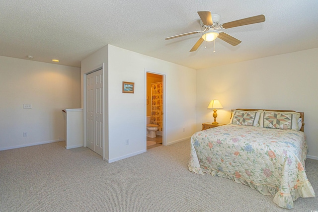 bedroom with baseboards, carpet flooring, connected bathroom, and ceiling fan