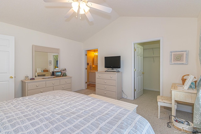 bedroom with a spacious closet, a ceiling fan, light colored carpet, and lofted ceiling