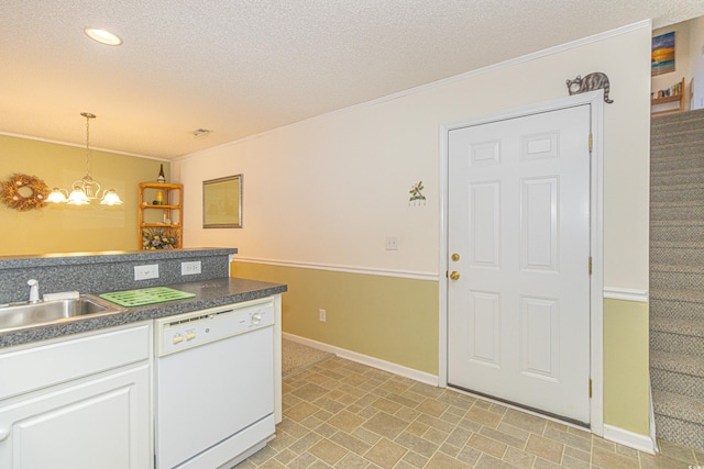 kitchen with baseboards, white dishwasher, a textured ceiling, a sink, and hanging light fixtures