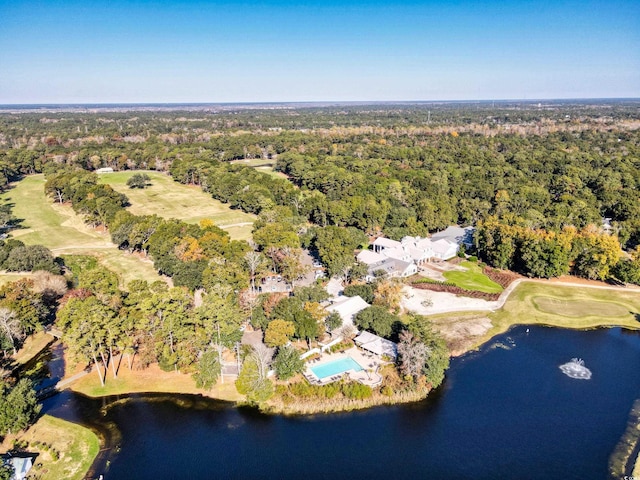 aerial view of property and surrounding area with a nearby body of water, a heavily wooded area, and a golf club