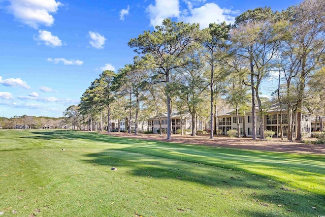 view of property's community with a lawn