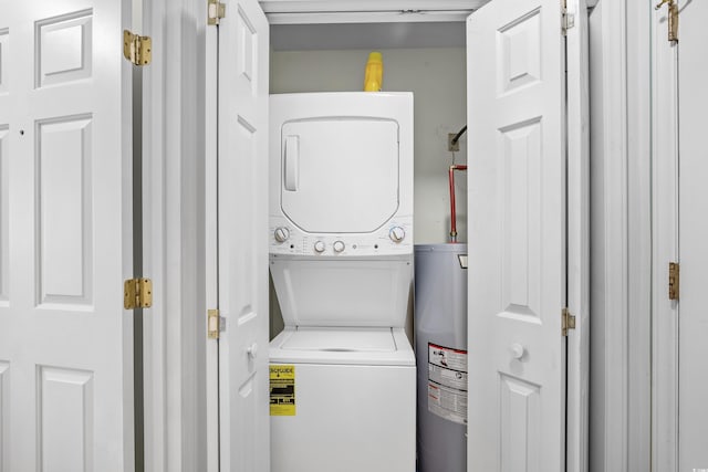 laundry area with stacked washer and clothes dryer and water heater