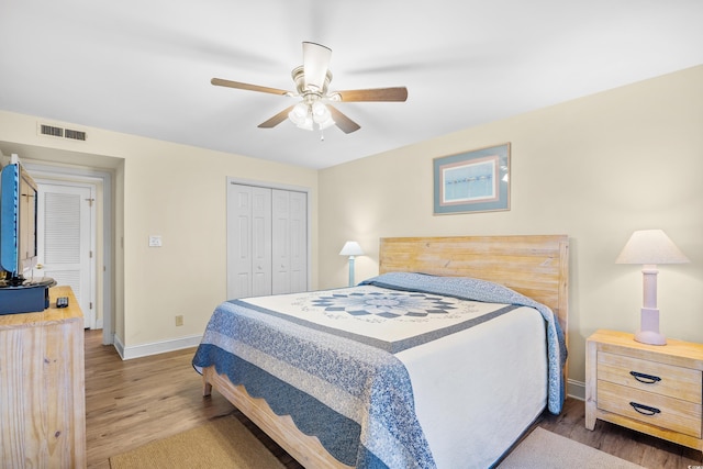 bedroom featuring wood finished floors, baseboards, a closet, and ceiling fan