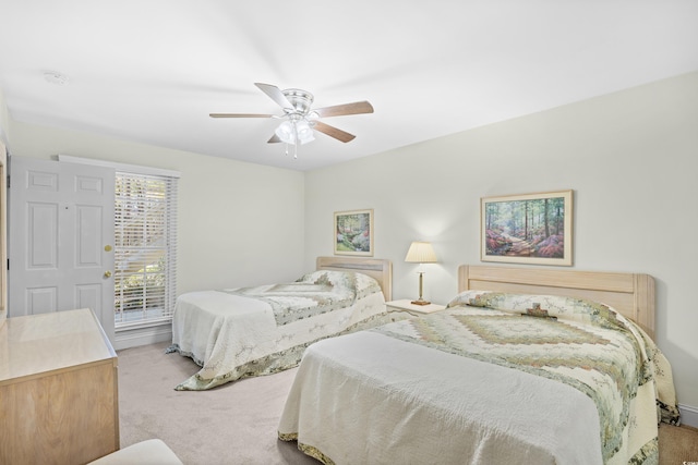 bedroom featuring light colored carpet and a ceiling fan
