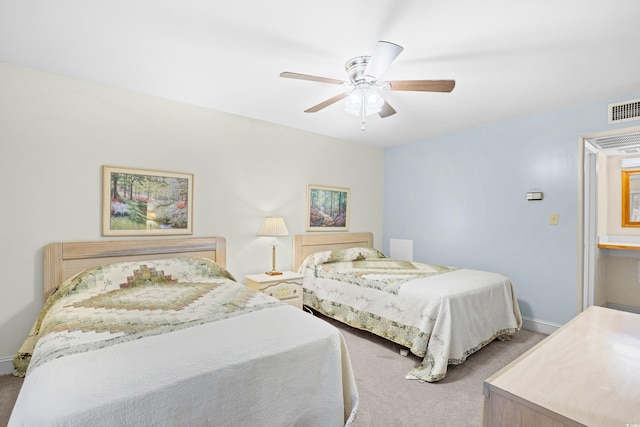 carpeted bedroom with a ceiling fan and baseboards