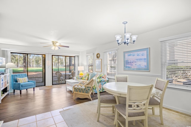 dining room featuring a chandelier, light tile patterned floors, plenty of natural light, and ceiling fan