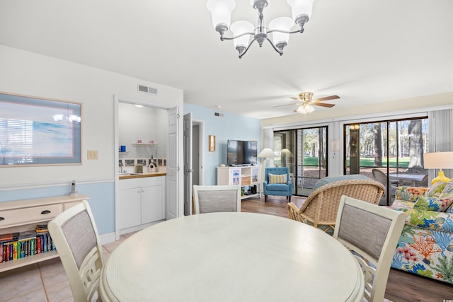 dining area with a chandelier and ceiling fan