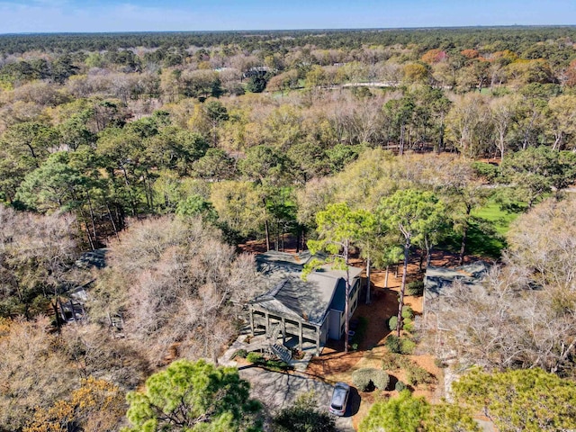 aerial view of property and surrounding area featuring a forest