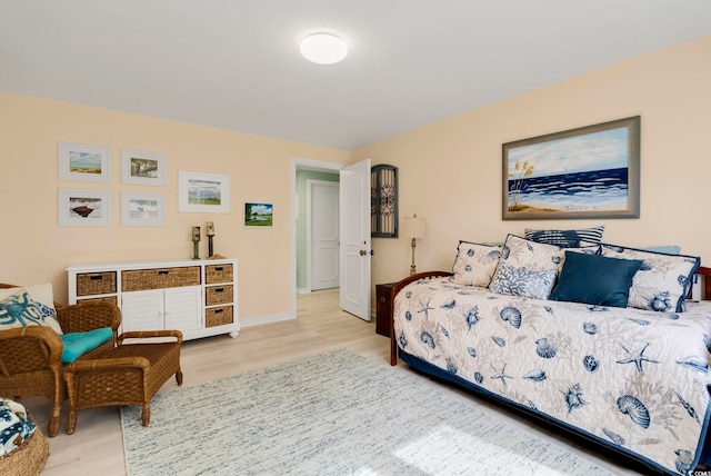bedroom with baseboards and wood finished floors