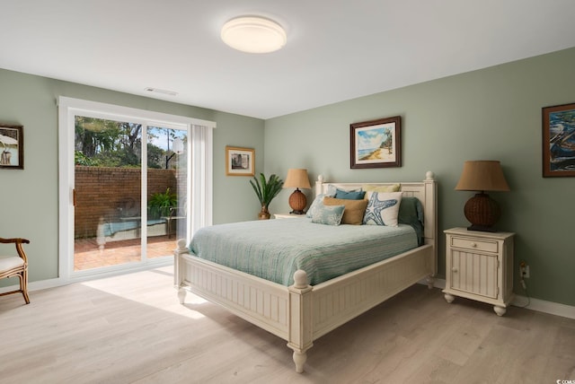 bedroom featuring light wood-style flooring, access to exterior, baseboards, and visible vents