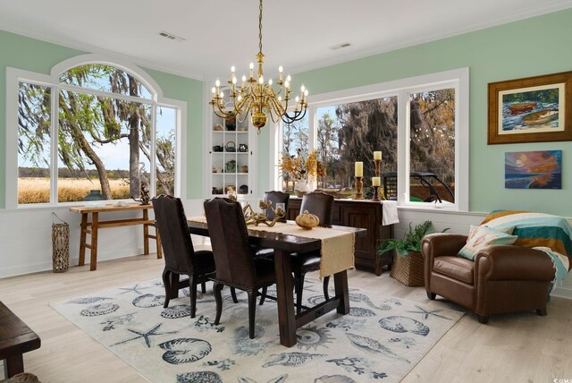 52 Trimmings Ct, Pawleys Island, SC 29585 - dining room featuring wood finished floors, visible vents, a notable chandelier, and a healthy amount of sunlight