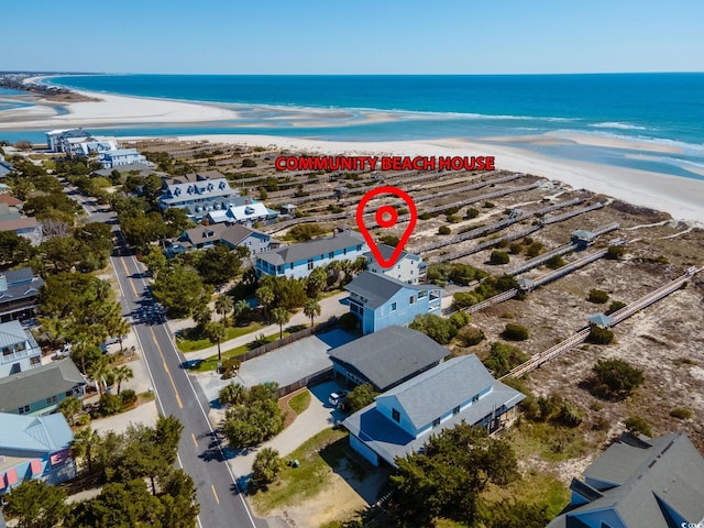 drone / aerial view featuring a beach view and a water view
