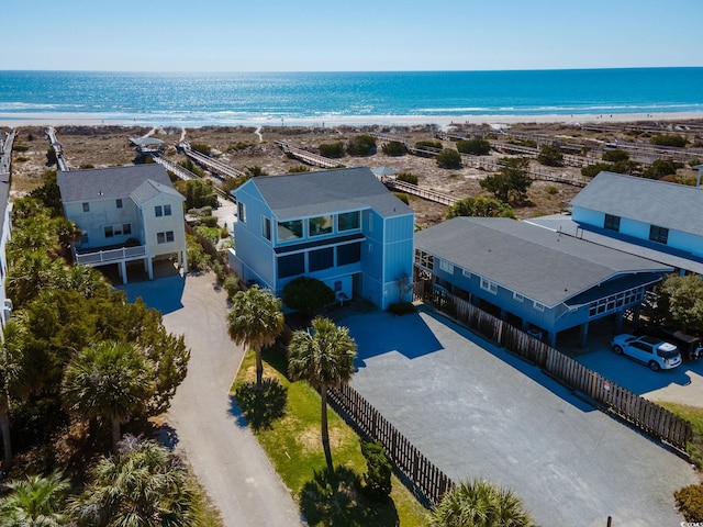 drone / aerial view featuring a beach view and a water view