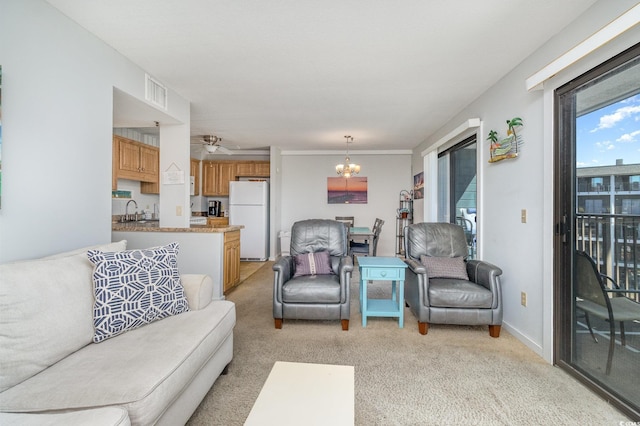 5905 S Kings Hwy Unit 439-B, Myrtle Beach, SC 29577 - living area featuring visible vents, ceiling fan with notable chandelier, and light carpet