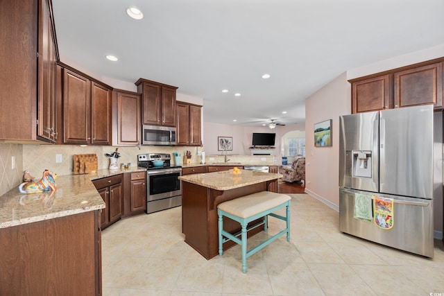 1112 Raven Cliff Ct, Conway, SC 29526 - kitchen with stainless steel appliances, light stone countertops, recessed lighting, a center island, and decorative backsplash