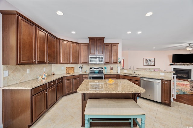 1112 Raven Cliff Ct, Conway, SC 29526 - kitchen with appliances with stainless steel finishes, a peninsula, light tile patterned flooring, a sink, and recessed lighting