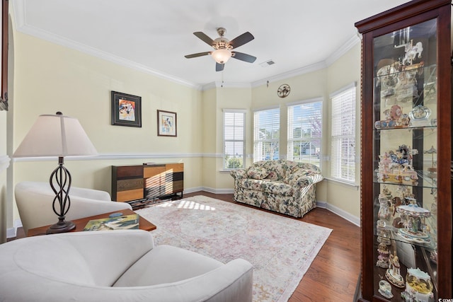 1112 Raven Cliff Ct, Conway, SC 29526 - living area featuring healthy amount of natural light, wood finished floors, ceiling fan, crown molding, and baseboards