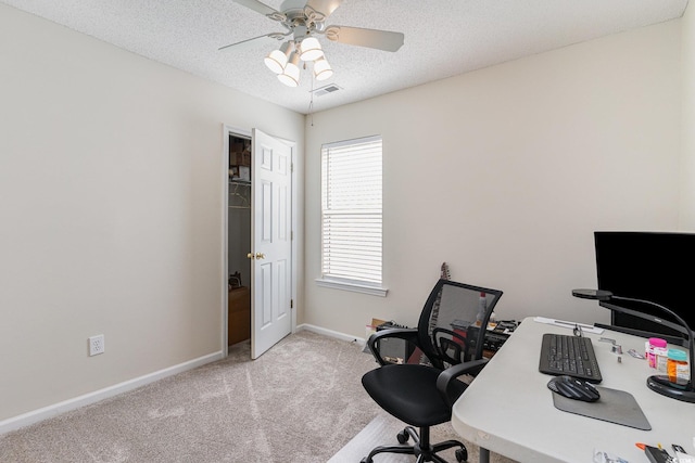 carpeted office space with baseboards, a textured ceiling, and ceiling fan