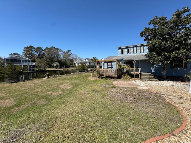 613 23rd Ave N, North Myrtle Beach, SC 29582 - view of grassy yard with a deck with water view