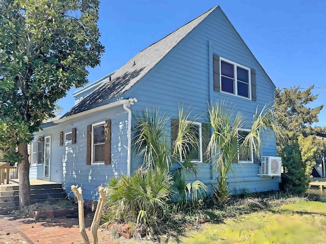 613 23rd Ave N, North Myrtle Beach, SC 29582 - view of side of home with a deck, roof with shingles, and cooling unit