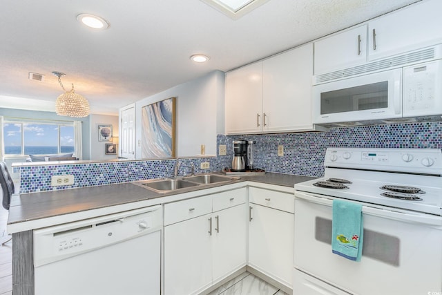 707 S Ocean Blvd Unit 602, North Myrtle Beach, SC 29582 - kitchen featuring white appliances, a peninsula, a sink, white cabinetry, and recessed lighting