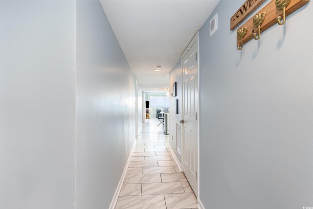 707 S Ocean Blvd Unit 602, North Myrtle Beach, SC 29582 - hallway featuring light marble finish floors and baseboards