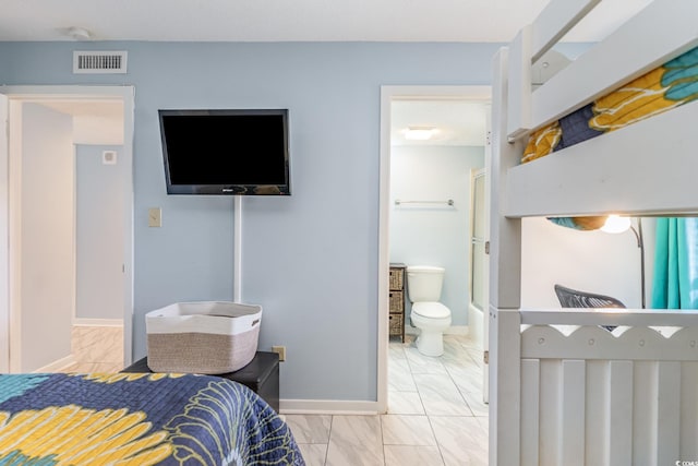 707 S Ocean Blvd Unit 602, North Myrtle Beach, SC 29582 - bedroom with marble look tiles, baseboards, and connected bathroom
