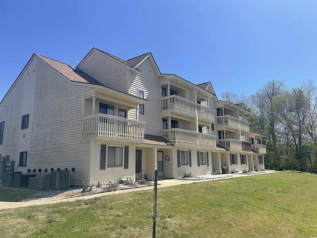 510 Fairwood Lakes Dr Unit 18J, Myrtle Beach, SC 29588 - rear view of house with central AC unit and a lawn