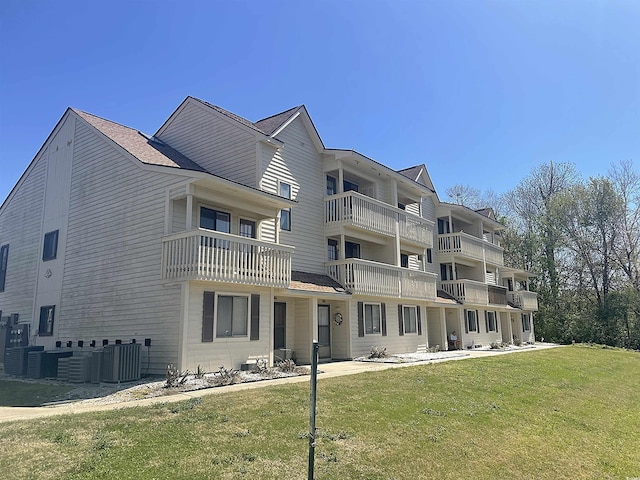 510 Fairwood Lakes Dr Unit 18J, Myrtle Beach, SC 29588 - rear view of house with central AC unit and a lawn