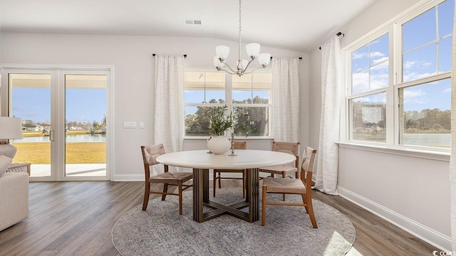 dining area with baseboards, a chandelier, vaulted ceiling, and dark wood-style floors