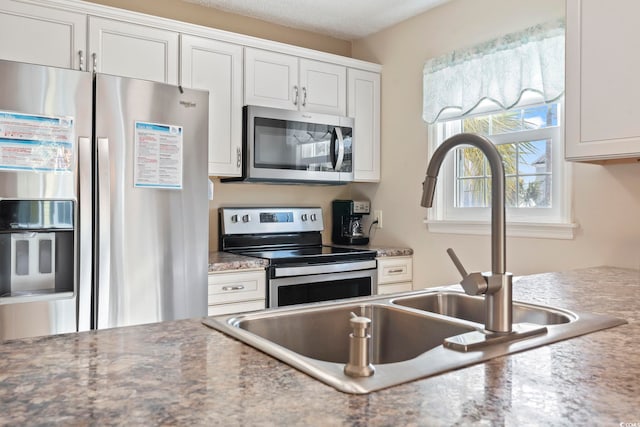 1425 N Waccamaw Dr Unit 123, Garden City Beach, SC 29576 - kitchen featuring stainless steel appliances, a sink, white cabinets, and light countertops