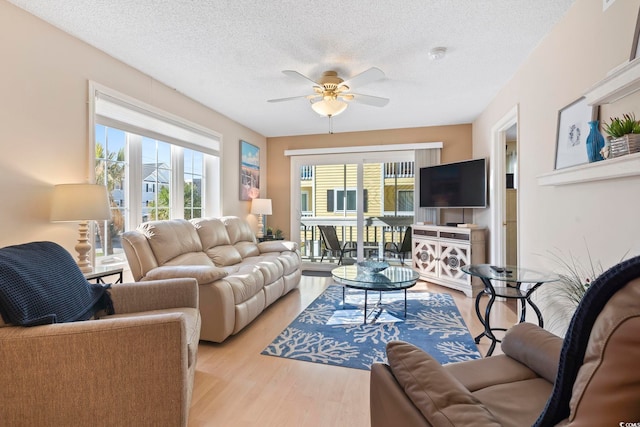 1425 N Waccamaw Dr Unit 123, Garden City Beach, SC 29576 - living room with ceiling fan, healthy amount of natural light, a textured ceiling, and light wood finished floors