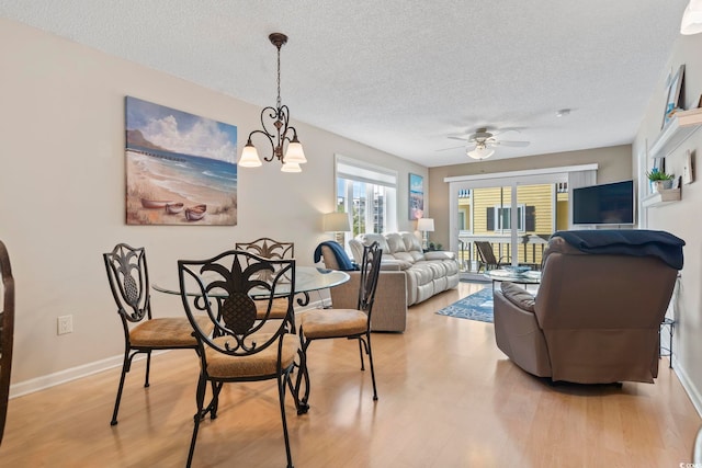 1425 N Waccamaw Dr Unit 123, Garden City Beach, SC 29576 - dining room with light wood-style flooring, a textured ceiling, ceiling fan, and baseboards