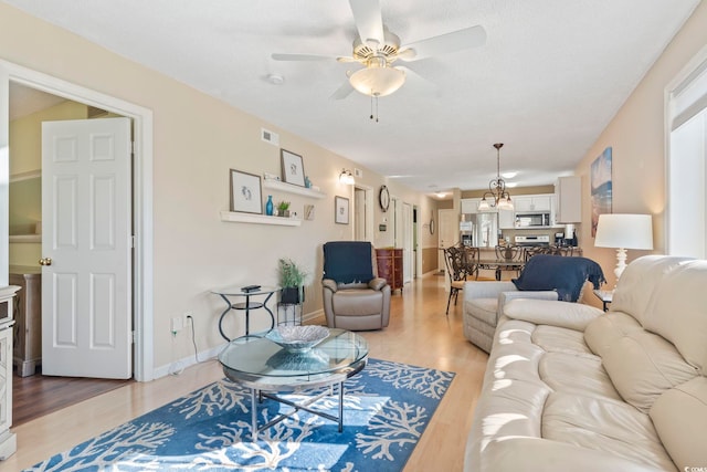 1425 N Waccamaw Dr Unit 123, Garden City Beach, SC 29576 - living room featuring a ceiling fan, light wood-type flooring, and baseboards