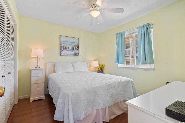 1425 N Waccamaw Dr Unit 123, Garden City Beach, SC 29576 - bedroom with dark wood-style flooring, a closet, a ceiling fan, and baseboards