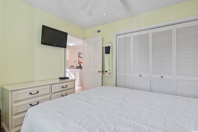 1425 N Waccamaw Dr Unit 123, Garden City Beach, SC 29576 - bedroom featuring a closet, a sink, and ceiling fan