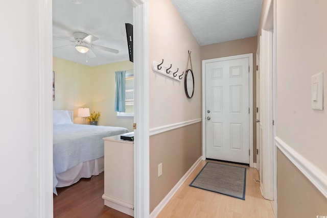 1425 N Waccamaw Dr Unit 123, Garden City Beach, SC 29576 - doorway to outside featuring wood finished floors, ceiling fan, a textured ceiling, and baseboards