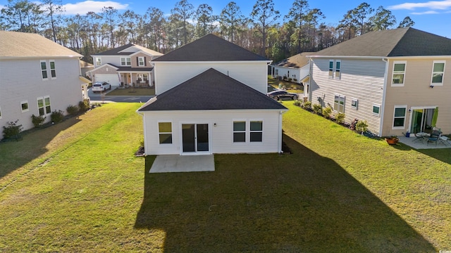 rear view of house with a patio area, a yard, and a residential view