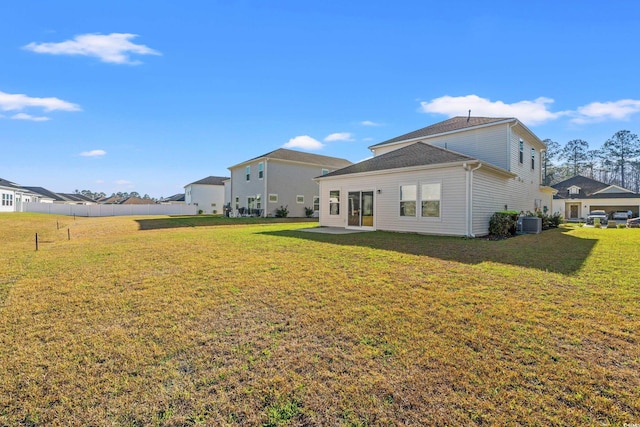 back of property featuring central AC, a yard, and a patio area