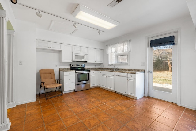 3494 Cactus St Unit 3494, Myrtle Beach, SC 29577 - kitchen featuring white appliances, rail lighting, a sink, white cabinetry, and light stone counters