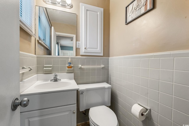 3494 Cactus St Unit 3494, Myrtle Beach, SC 29577 - half bath with tile walls, toilet, vanity, and a wainscoted wall