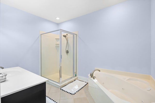 bathroom with a whirlpool tub, tile patterned floors, a stall shower, and vanity