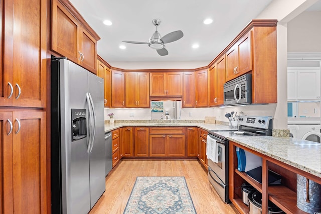 kitchen featuring ceiling fan, light stone countertops, stainless steel appliances, brown cabinets, and light wood finished floors