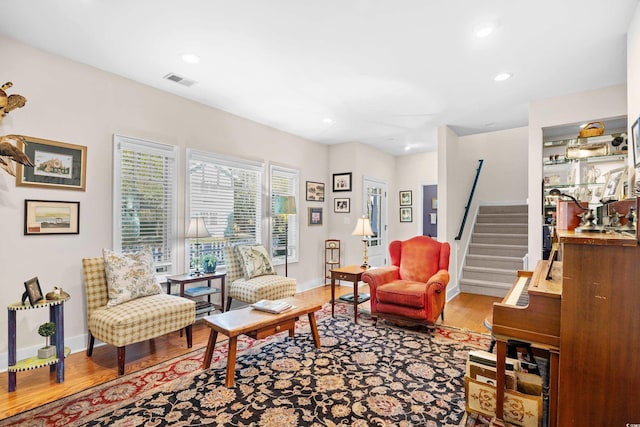 living area featuring visible vents, recessed lighting, wood finished floors, stairs, and baseboards