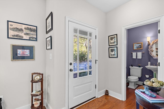 entrance foyer featuring wood finished floors and baseboards