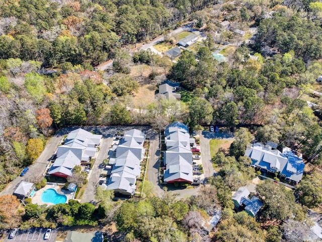 drone / aerial view featuring a forest view and a residential view