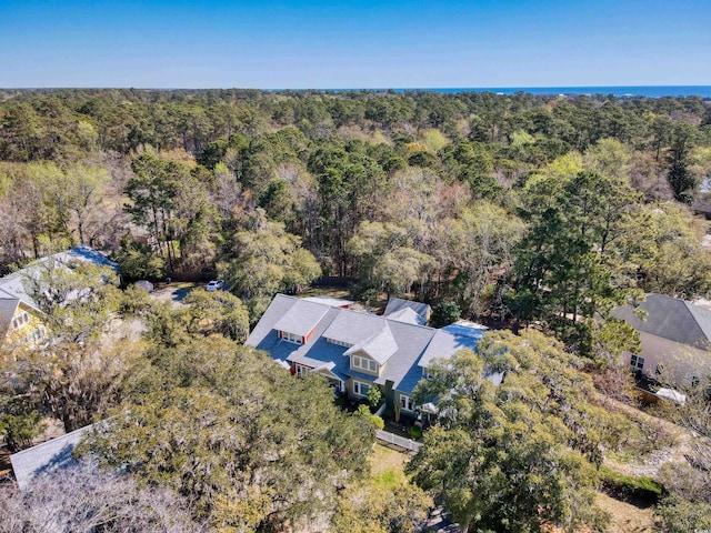 drone / aerial view featuring a forest view
