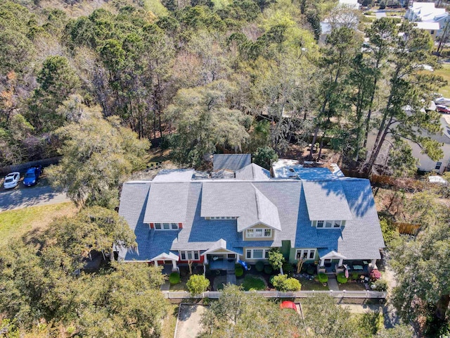 drone / aerial view with a wooded view