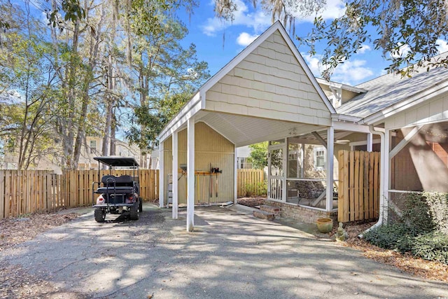 view of vehicle parking featuring a detached carport and fence