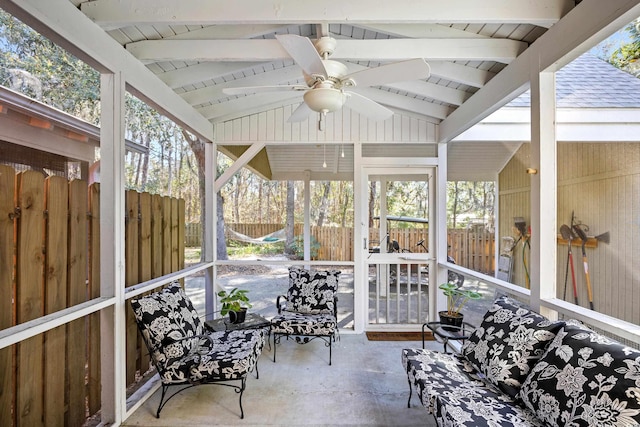 sunroom / solarium featuring ceiling fan and beam ceiling